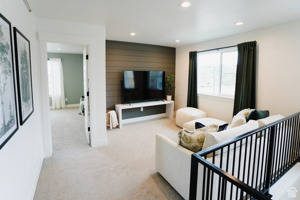 Carpeted living area featuring recessed lighting and baseboards