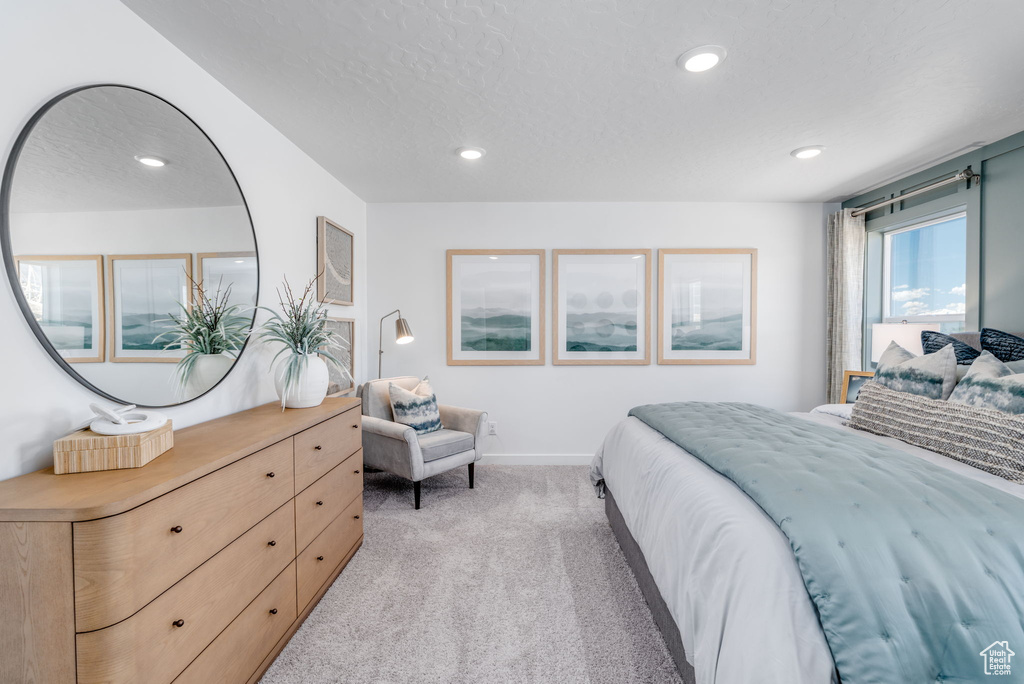 Bedroom with light colored carpet, recessed lighting, and baseboards