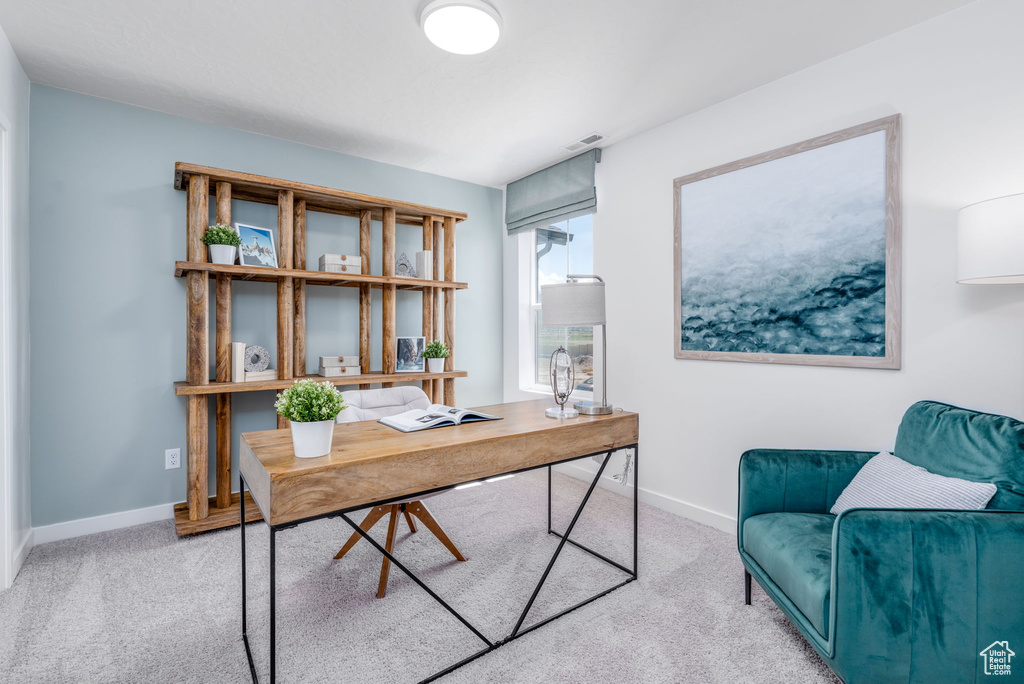 Carpeted office space with baseboards