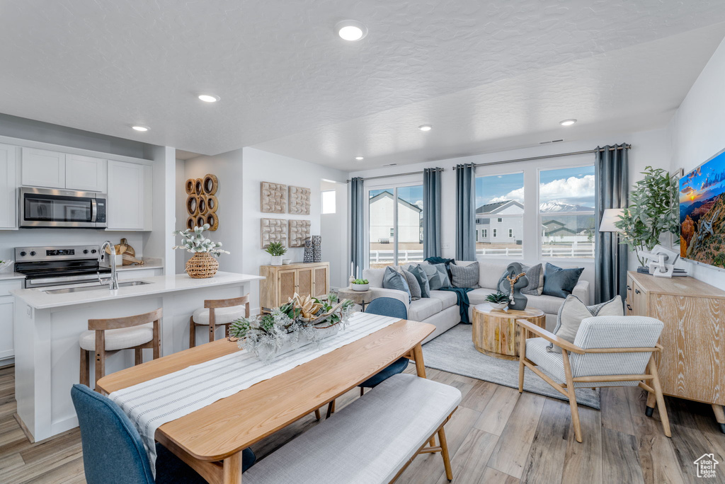 Dining room featuring light wood-type flooring and recessed lighting