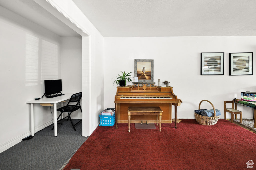 Office area featuring carpet and baseboards