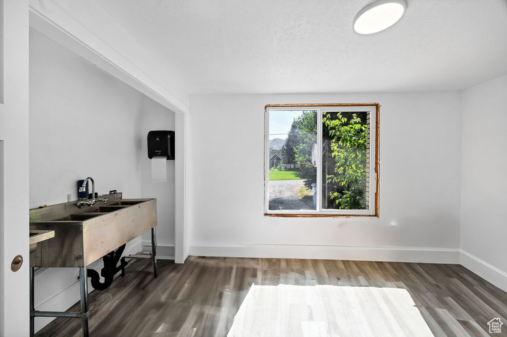 Office with wood finished floors and baseboards