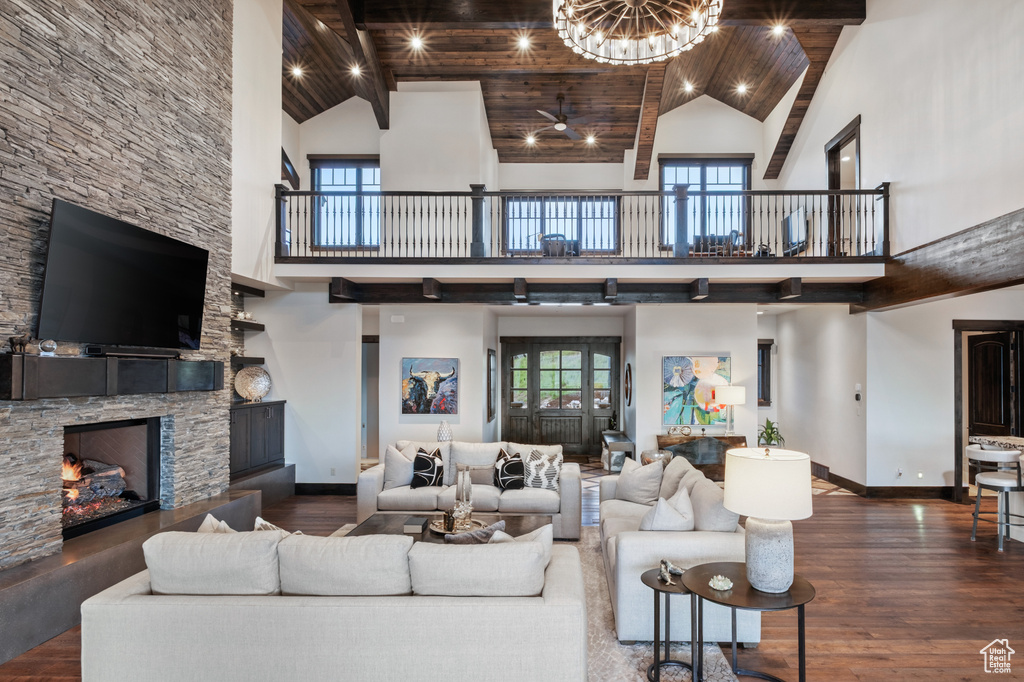 Living area featuring high vaulted ceiling, baseboards, and wood finished floors
