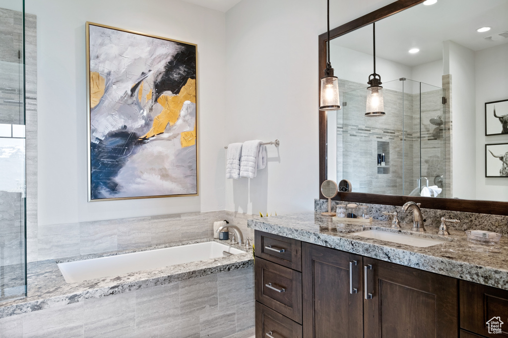 Bathroom with vanity, a garden tub, a shower stall, and recessed lighting