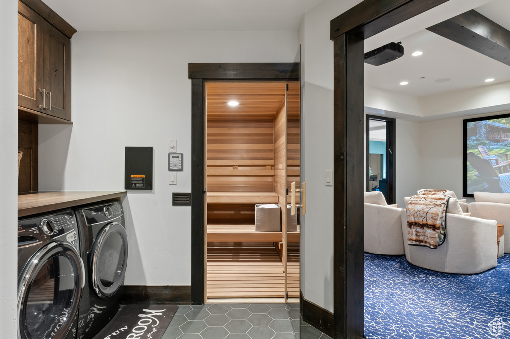 Washroom featuring cabinet space, washing machine and dryer, tile patterned flooring, recessed lighting, and baseboards