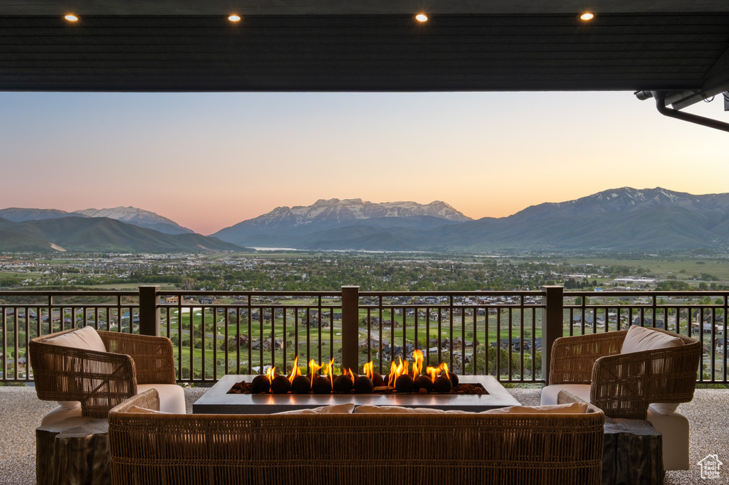 Patio terrace at dusk with a mountain view and outdoor lounge area