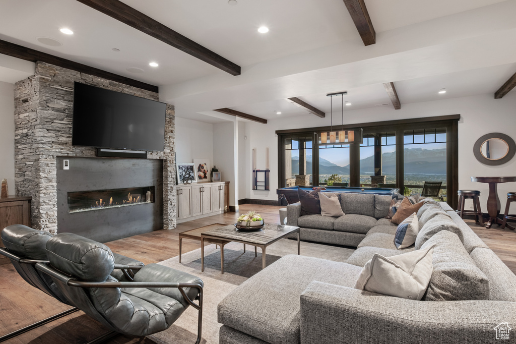 Living area with wood finished floors, beamed ceiling, a fireplace, billiards table, and recessed lighting