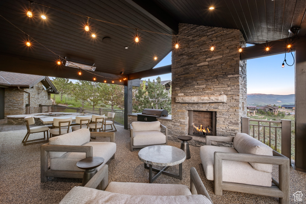 View of patio / terrace with an outdoor living space with a fireplace and a mountain view