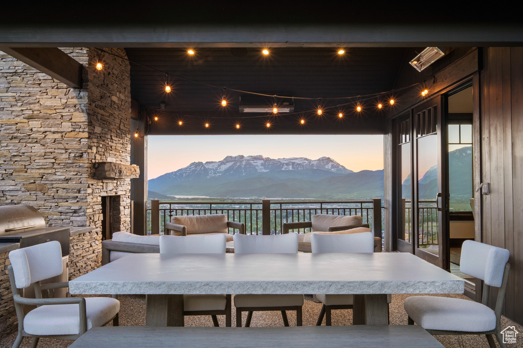 View of patio / terrace featuring a mountain view, outdoor dining area, and a fireplace