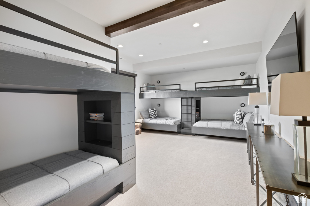 Carpeted bedroom featuring beam ceiling and recessed lighting