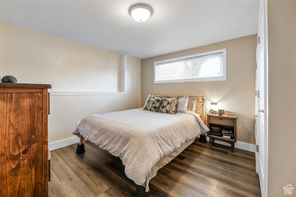 Bedroom featuring wood finished floors and baseboards