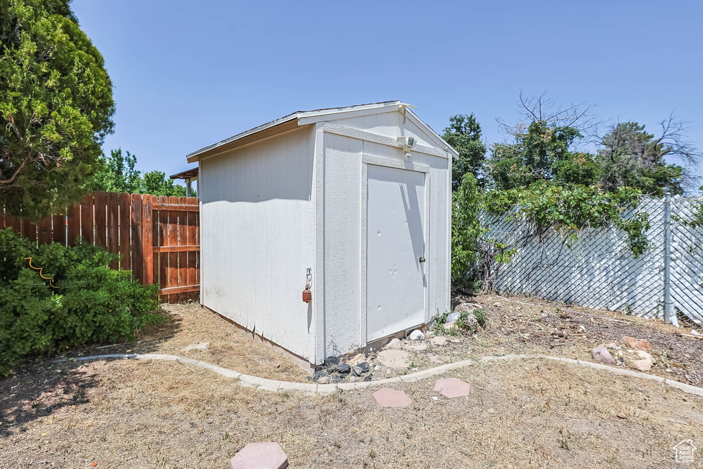 View of shed featuring a fenced backyard