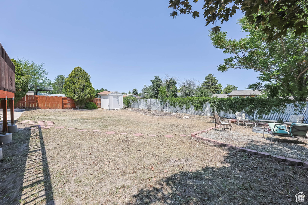 Fenced backyard featuring a patio area and an outdoor fire pit