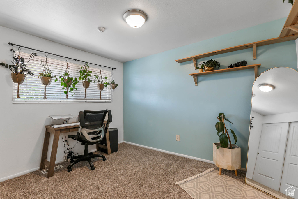 Carpeted office with baseboards