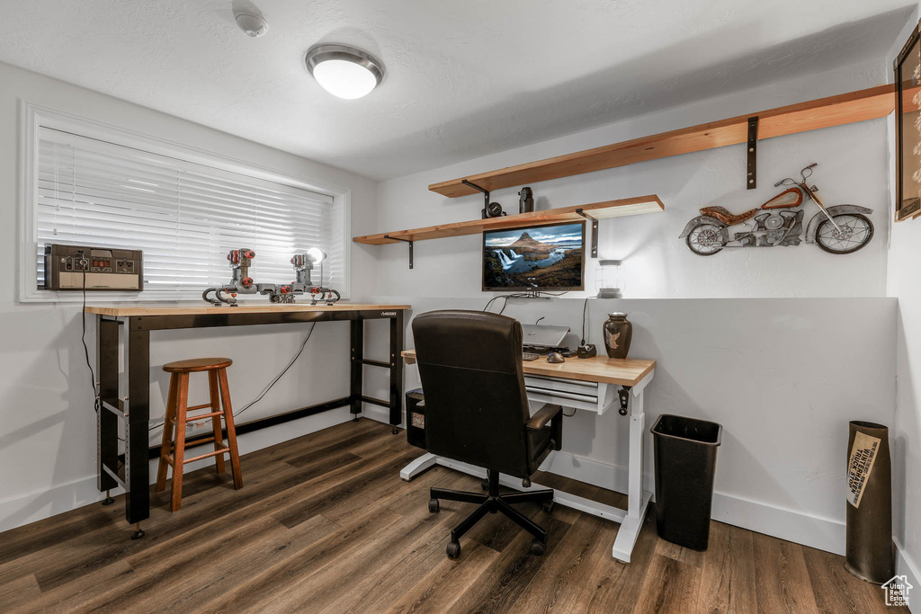 Home office featuring wood finished floors and baseboards