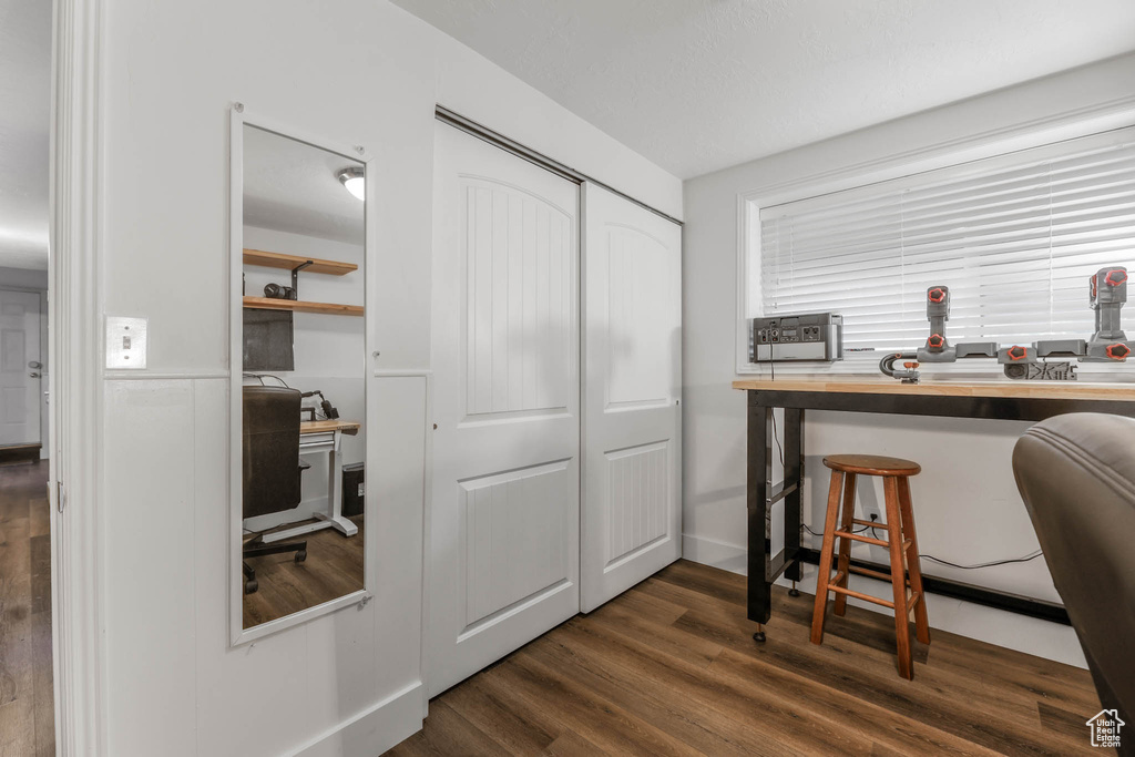Office area featuring dark wood-type flooring