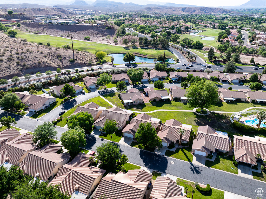 Aerial perspective of suburban area featuring a local golf course and a water and mountain view