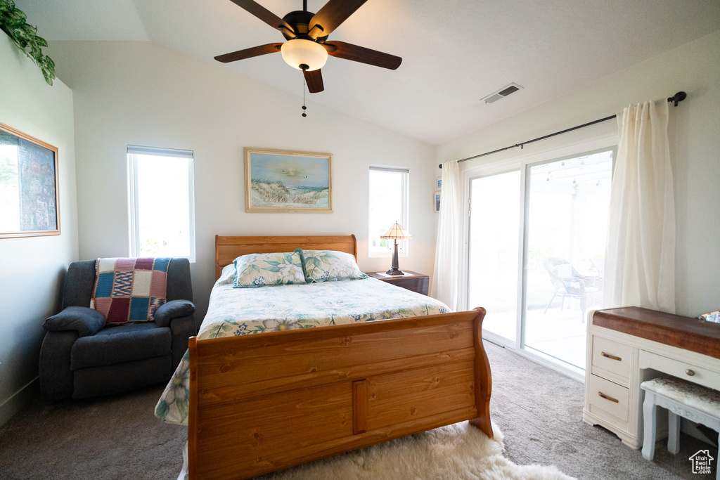 Bedroom with vaulted ceiling, access to outside, light colored carpet, and a ceiling fan