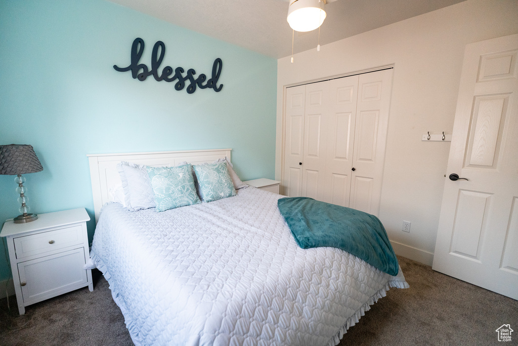 Bedroom with carpet floors, a closet, and baseboards