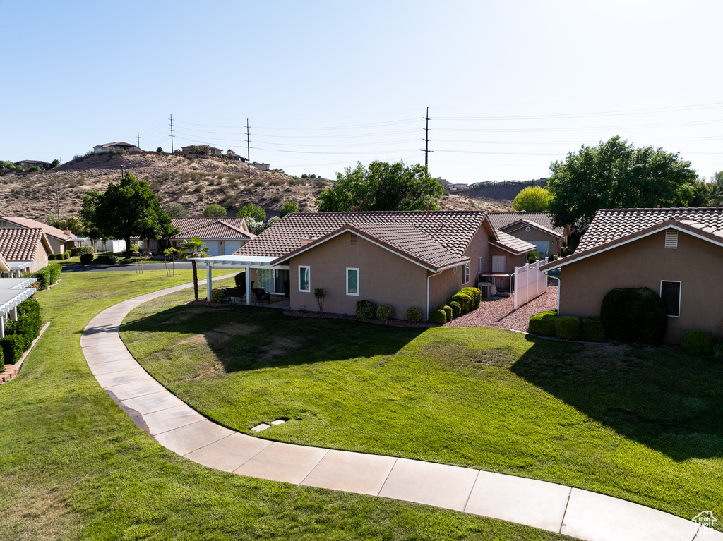 View of side of home featuring a tiled roof and stucco siding