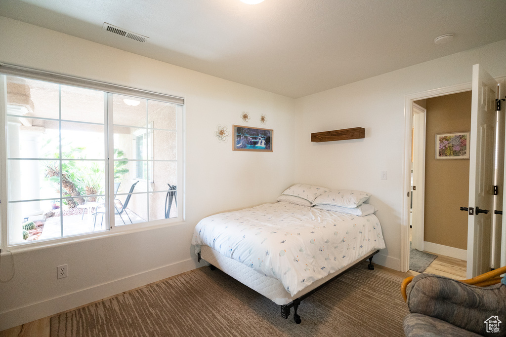 Bedroom with baseboards and multiple windows