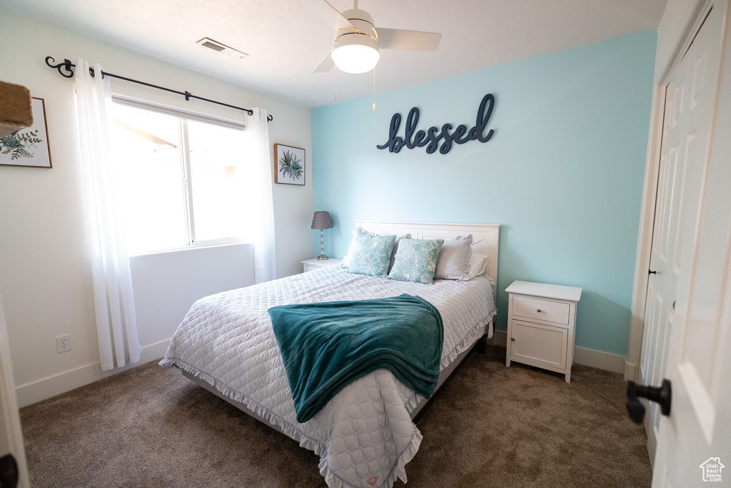 Bedroom with a closet, carpet, and baseboards