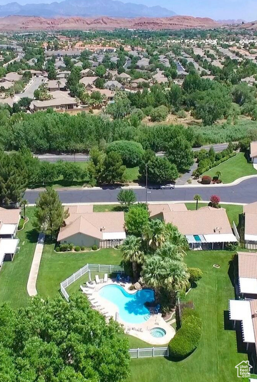 Aerial view of residential area featuring a pool area and mountains