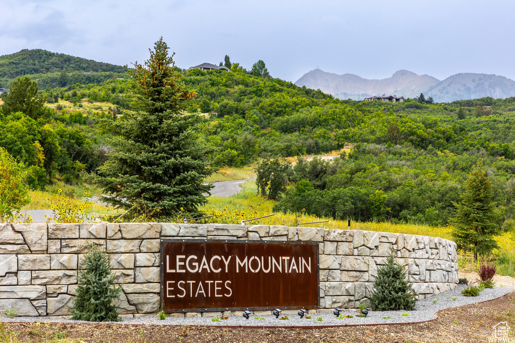 Community sign featuring a forest view and a mountain view