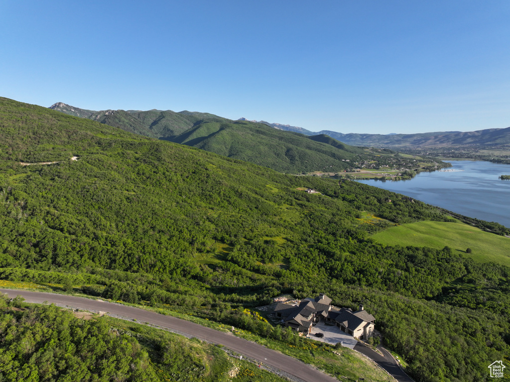 Drone / aerial view of a water and mountain view and a heavily wooded area
