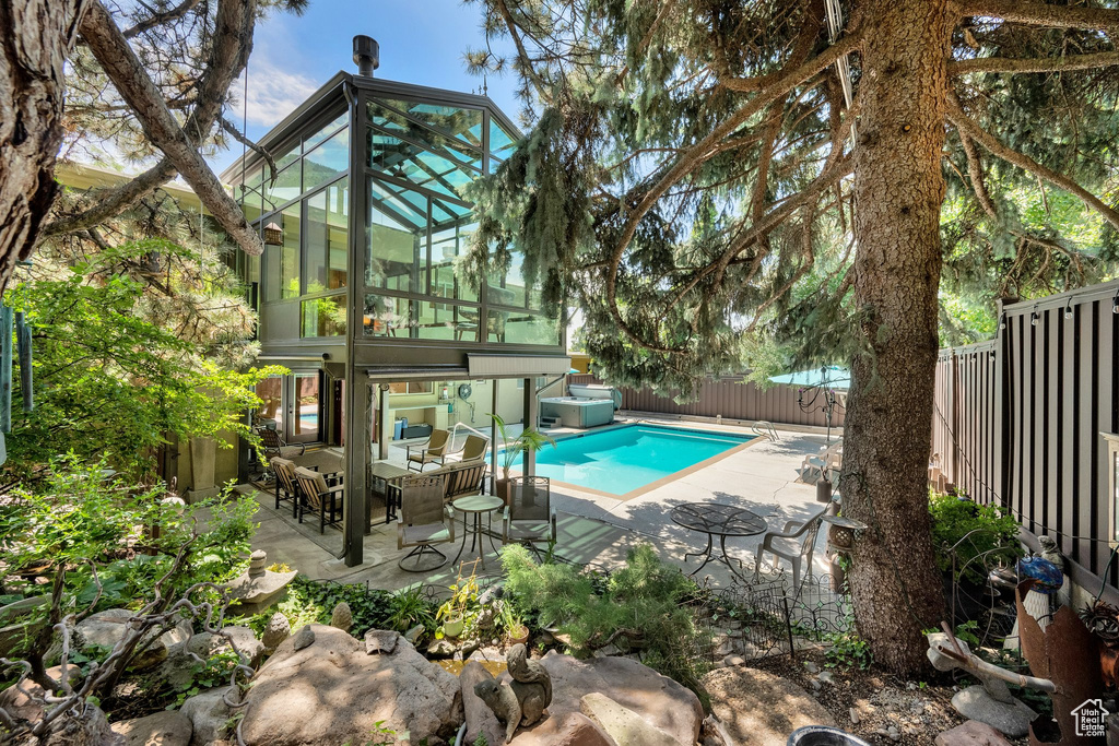 View of pool with a fenced backyard, an outdoor living space, and a patio