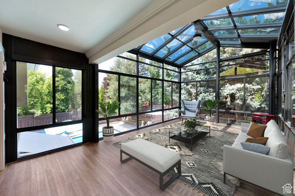 Sunroom / solarium featuring lofted ceiling