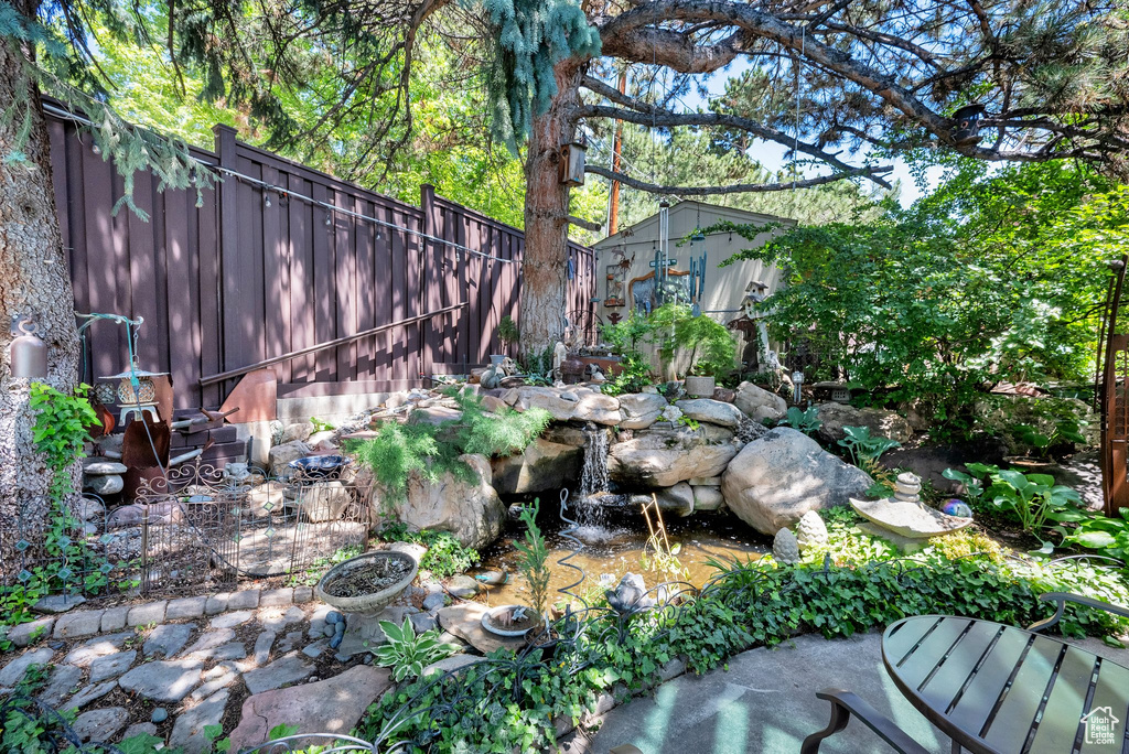View of yard with a small pond