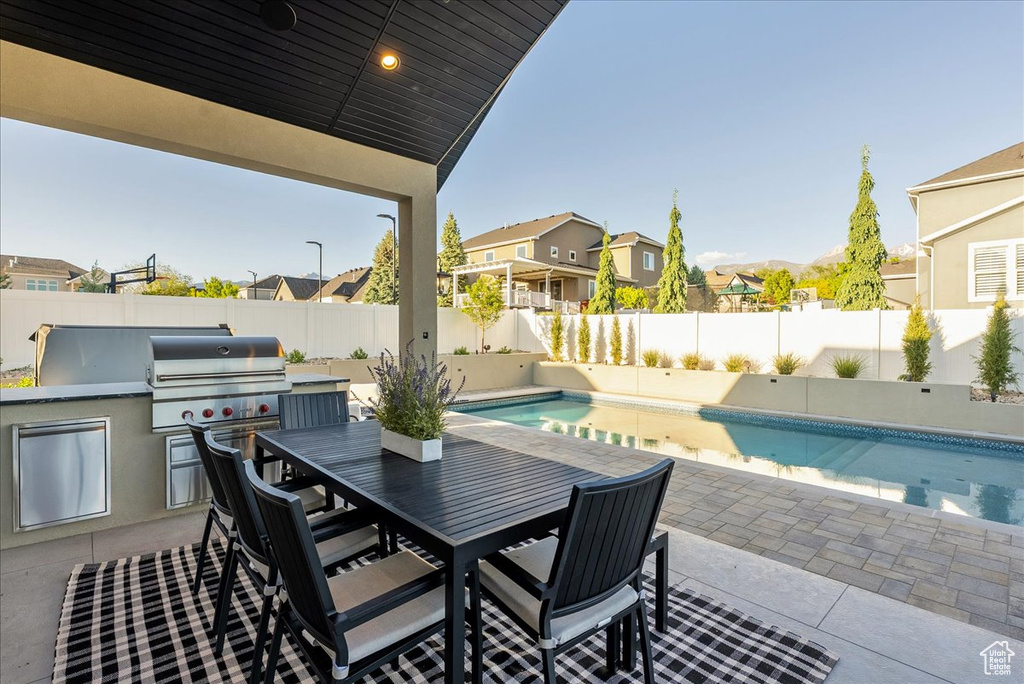 Fenced backyard with a patio area, a residential view, and outdoor dining space
