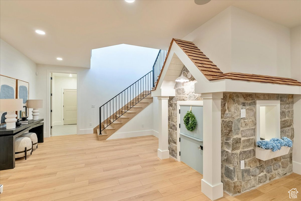 Staircase with wood finished floors, recessed lighting, and baseboards