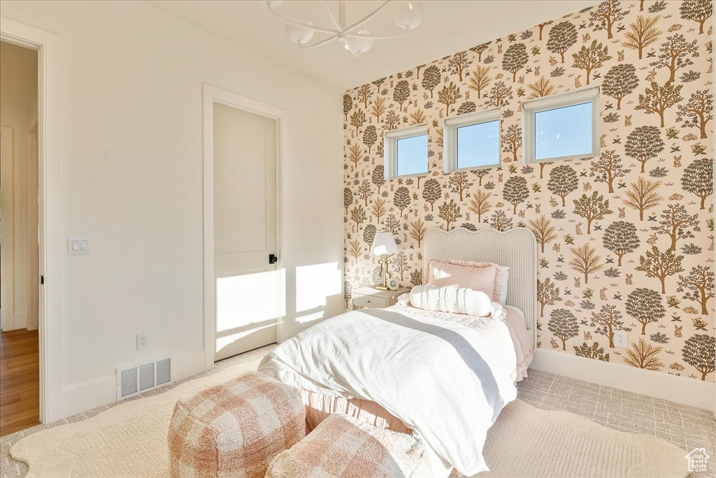 Bedroom with a chandelier and baseboards