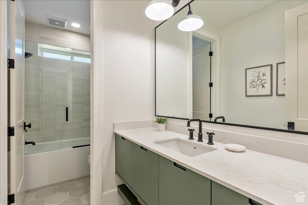 Full bath with vanity, combined bath / shower with glass door, toilet, tile patterned flooring, and recessed lighting