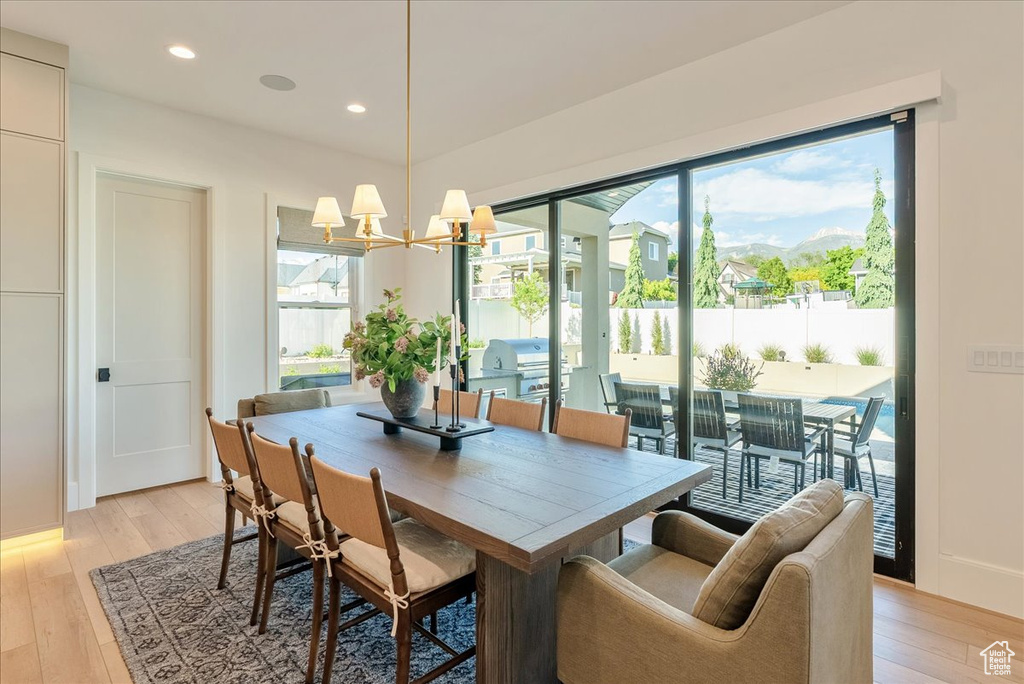 Dining area featuring light wood-style floors, a chandelier, and recessed lighting
