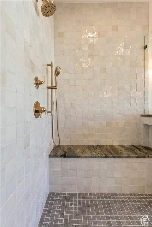 Full bath featuring tiled shower