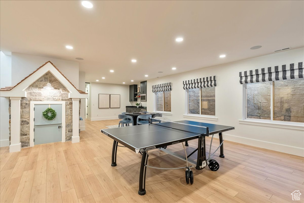 Playroom with light wood-style flooring, baseboards, and recessed lighting