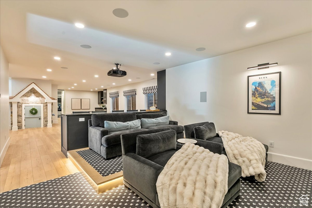 Home theater room featuring recessed lighting, baseboards, and light wood finished floors