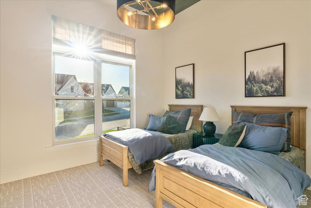 Bedroom featuring light colored carpet and baseboards