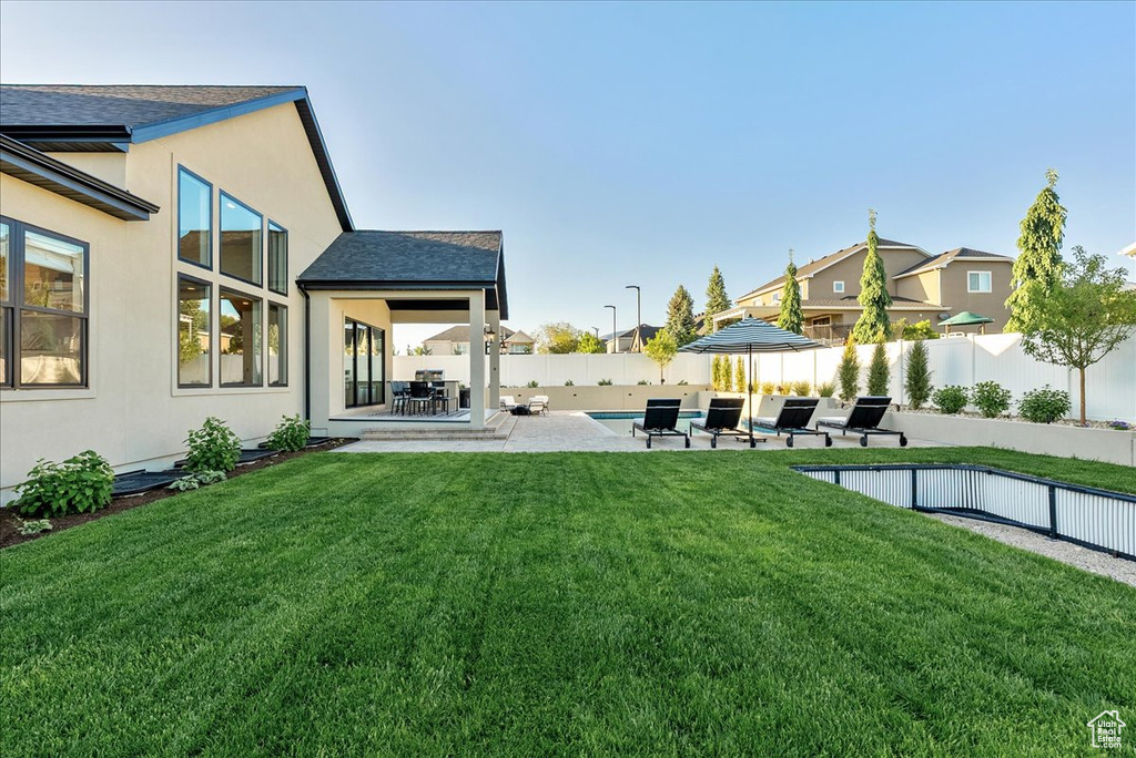 View of yard featuring a patio and a residential view