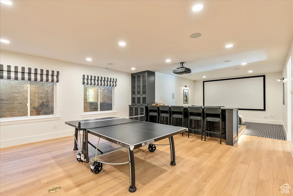 Game room featuring baseboards, light wood-style floors, and recessed lighting