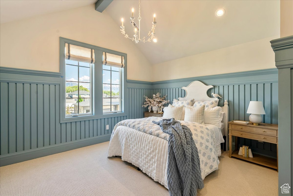 Carpeted bedroom with a chandelier, wainscoting, and recessed lighting