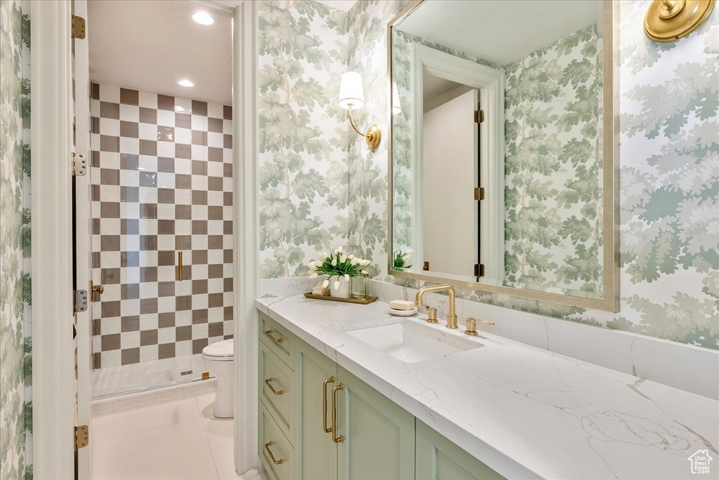 Bathroom with vanity, toilet, a shower stall, recessed lighting, and wallpapered walls