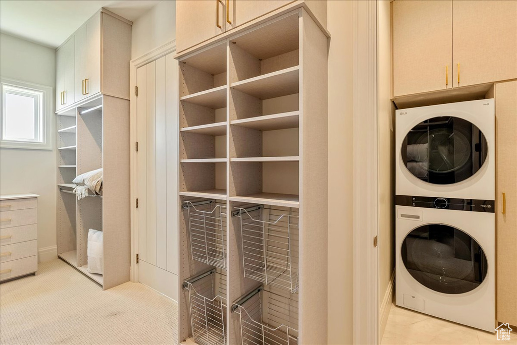 Washroom with stacked washing machine and dryer and cabinet space