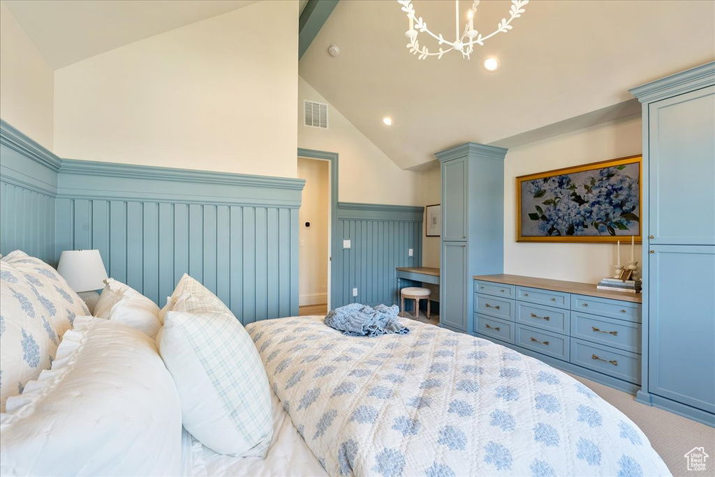 Bedroom featuring wainscoting, lofted ceiling, a chandelier, recessed lighting, and light colored carpet