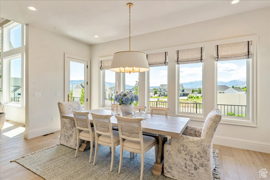 Dining room featuring baseboards, light wood-style flooring, and recessed lighting
