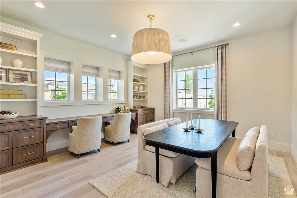 Dining space with light wood-type flooring and recessed lighting