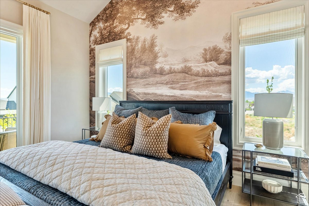 Bedroom featuring vaulted ceiling and wood finished floors